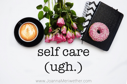 a cup of coffee, a group of pink roses, and a donut atop a black journal all symbols of so called self-care