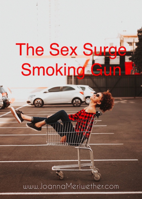 a woman of color wearing jeans and a plaid shirt sitting in a shopping cart, smiliing
